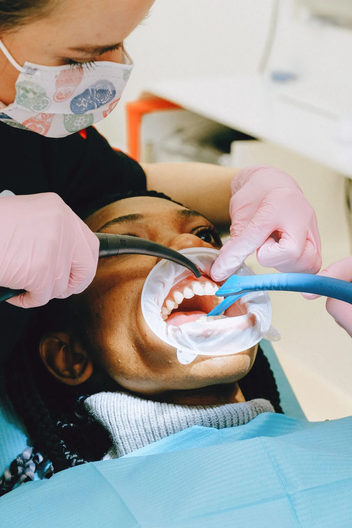 Dental professional working on a patient’s teeth